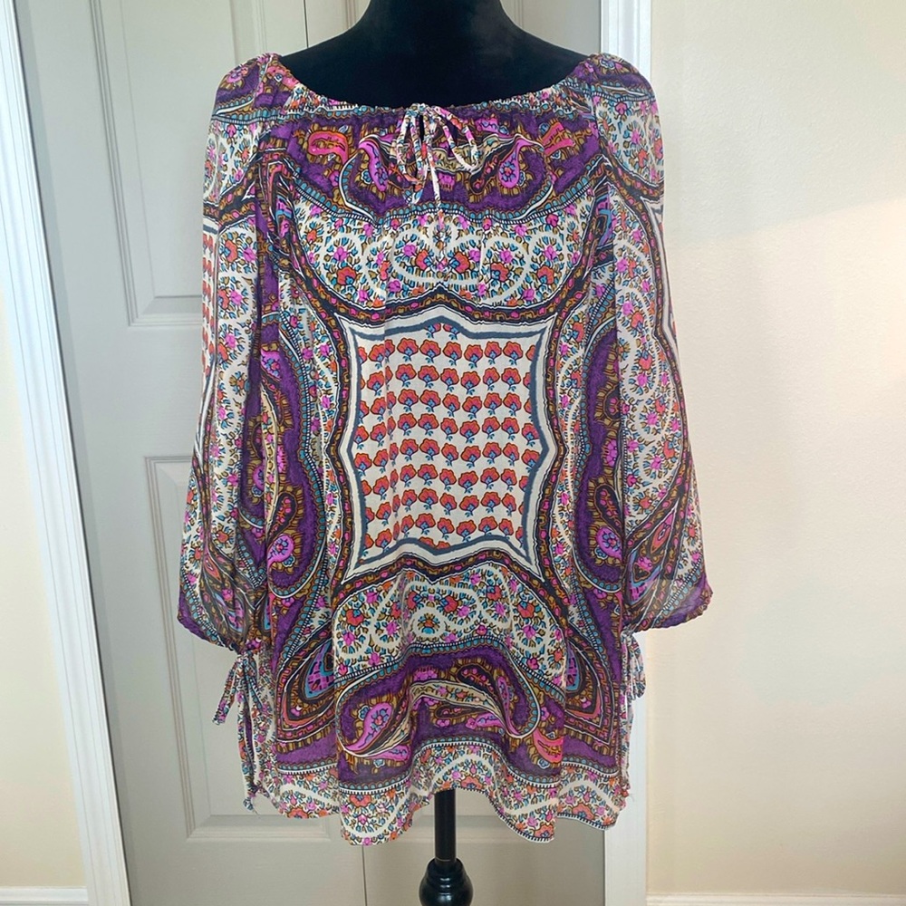 Very cute tunic, I recommend a camisole should be worn underneath. Size XL